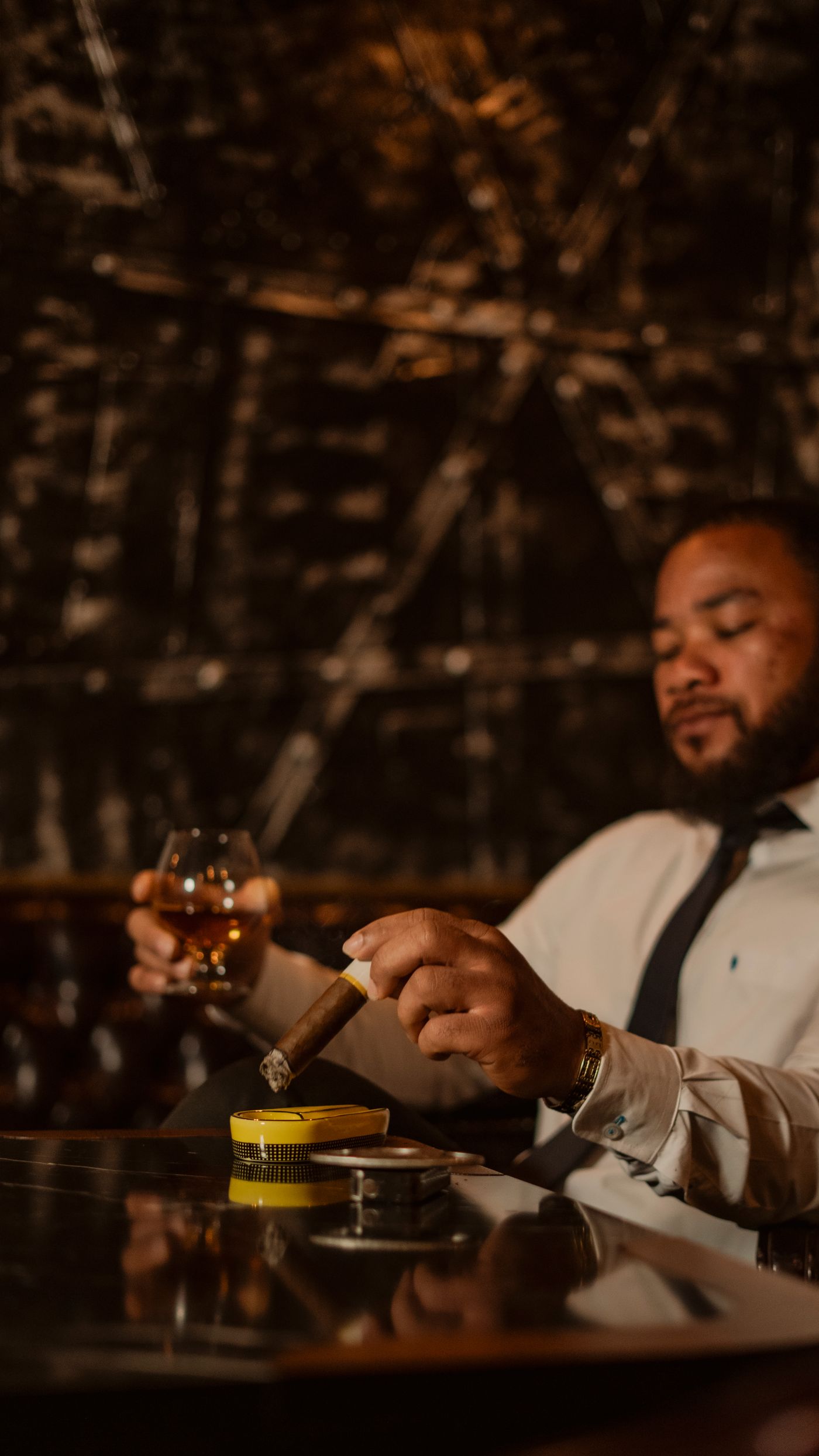 A member settled into a dim cigar lounge